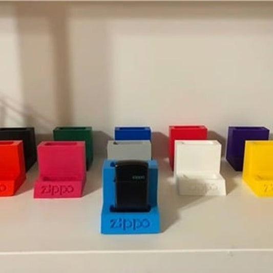 A royal blue display stand designed specifically for showcasing a single Zippo lighter. The stand features a sturdy base and a secure holder to keep the lighter in place. It is photographed against a white background.