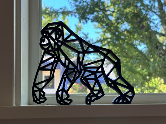 A black obsidian statue depicting a guerrilla gorilla in a standing pose.